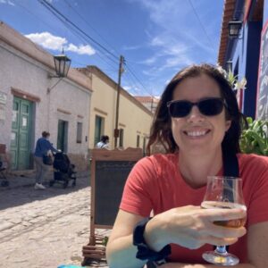 Woman drinking a beer in a small Argentinian village